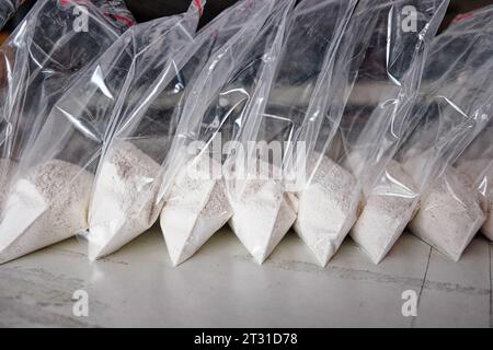 Un gran numero di bustine trasparenti riempite di polvere bianca. Polvere bianca confezionata in bustine piccole. Foto Stock