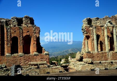 Vulcano Etna e le rovine dell'Antico Teatro Greco di Taormina (Teatro antico di Taormina) a Taormina, Sicilia, Italia, UE. Foto Stock