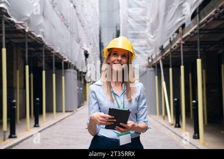 Ingegnere premuroso che tiene un tablet PC giorno sognando in cantiere Foto Stock