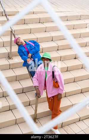 Amici multirazziali in piedi su gradini visti attraverso il fotogramma Foto Stock