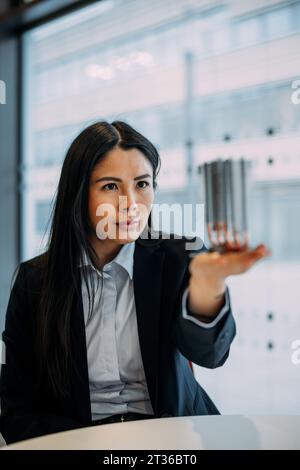Ingegnere che analizza il modulo di raffreddamento in ufficio Foto Stock