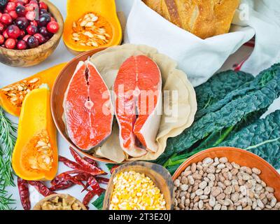 Coloratissima gamma di ingredienti vegetali autunnali con bistecche di salmone di salsiccia per un'alimentazione sana o senza carne, ringraziamento con pesce. Foto Stock