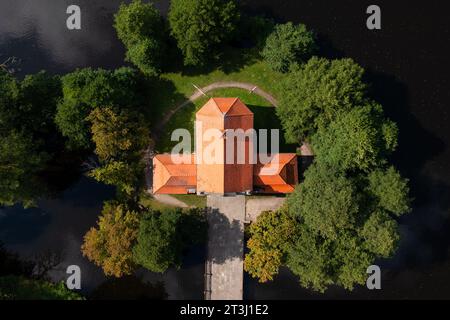 (NOTA DELL'EDITORE: Immagine scattata con un drone)Vista droni della Chiesa sull'acqua a Zwierzyniec. La chiesa sull'acqua di Zwierzyniec fu costruita nel XVIII secolo e la sua storia va ancora più a fondo. La città di Zwierzyniec e le zone circostanti appartenevano una volta alla famiglia Firlej, nota per il suo patrocinio artistico e religioso. Il parco nazionale di Roztocze si trova nella parte sud-orientale della Polonia, a Roztocze, nel voivodato del Lubelskie. È stato istituito il 10 maggio 1974. La gestione del parco ha sede nel Palazzo Plenipotenziario di Zwierzyniec. Foto Stock