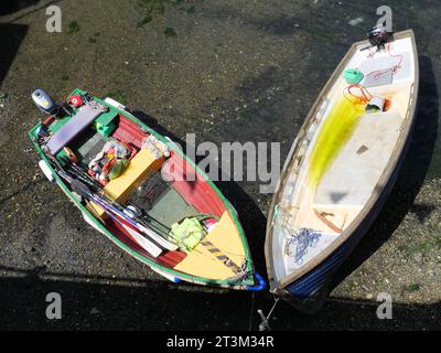 Vista dall'alto su due barche a remi che giacciono a terra con la bassa marea nel porto di Falmouth, Cornovaglia, Inghilterra Foto Stock