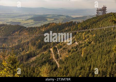 Vista aerea del ponte sospeso più lungo del mondo, di 721 metri, dello Sky bridge e della torre di osservazione, la Sky Walk nella foresta, splendida giornata autunnale. CZ Foto Stock