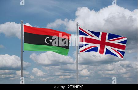 Regno Unito e Libia bandiere che sventolano insieme nel vento su cielo nuvoloso blu, concetto di relazione tra due paesi Foto Stock