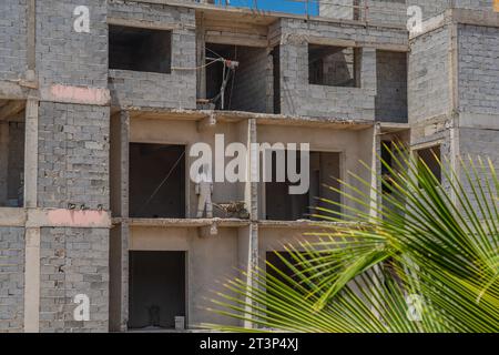 Santa Maria, Isola di Sal - Capo Verde, 02 ottobre 2023: Costruzione di un edificio incompiuto con un uomo in abito bianco Foto Stock