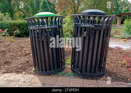 Due bidoni della spazzatura lungo il passaggio pedonale del parco, uno per le lattine e le bottiglie di plastica riciclabili, l'altro per i rifiuti di discarica Foto Stock