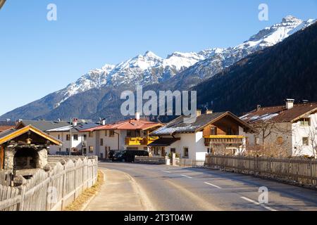 Villaggio alpino con montagna innevata sullo sfondo Foto Stock