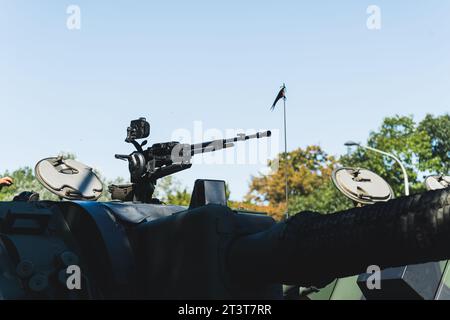 Parata militare all'aperto per scopi patriottici. Mitragliatrice moderna posizionata sulla sommità del carro armato militare. Cielo blu sullo sfondo. Foto di alta qualità Foto Stock