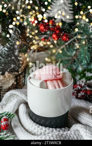 Cioccolata calda fatta in casa con mini marshmallow in una tazza smaltata blu. Stile rustico. Foto Stock