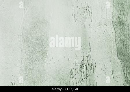 Sfondo in cemento ruvido verde grigio con base chiara più scura nelle cavità. Texture astratta per grafica o sfondo, vista dall'alto Foto Stock