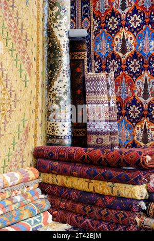 Il tappeto viene arrotolato ed esposto in una mostra di tappeti a pune, tappeto in seta con design floreale del Kashmir, pila di tappeti di qualità multicolore, Made in India Foto Stock