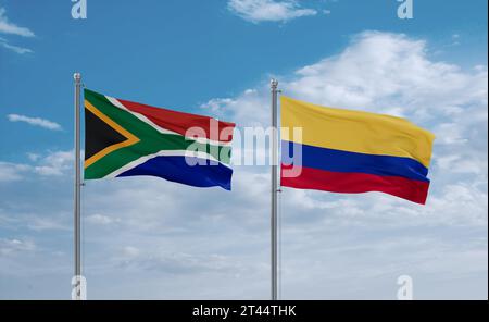 Le bandiere della Colombia e del Sudafrica sventolano insieme nel vento su un cielo nuvoloso blu, concetto di relazione tra due paesi Foto Stock