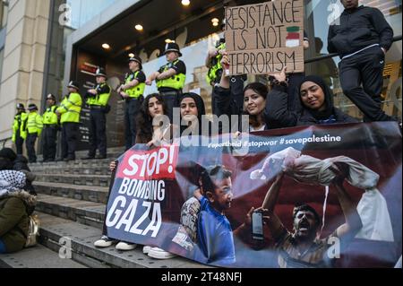 The Mailbox Birmingham, 29 ottobre 2023 - la polizia delle West Midlands evacuò la Mailbox e formò una linea intorno agli ingressi come una marcia della Palestina libera riunita fuori domenica pomeriggio. Circa 200 manifestanti sventolarono bandiere e cantarono "vergogna sulla BBC" con poliziotti che tenevano la linea. La BBC ha i suoi studi Midlands all'interno dell'edificio Mailbox nel centro di Birmingham. Vari segni e bambole bagnate di sangue sono stati lasciati sui gradini della proprietà. Credito: Stop Press Media/Alamy Live News Foto Stock