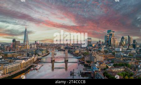 Vista aerea di Londra al tramonto guardando sul Tower Bridge verso la città, Shard e la stazione ferroviaria di London Bridge. . Acque calme e cieli colorati. Foto Stock