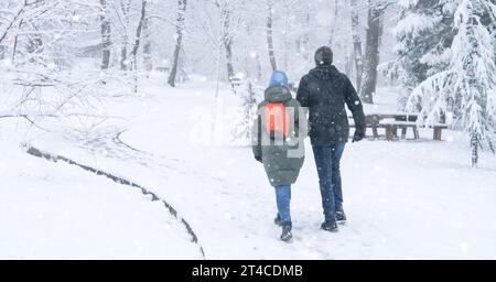 Amate le coppie che camminano nel parco invernale nella neve. Foto Stock