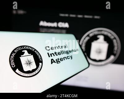 Telefono cellulare con il logo dell'American Central Intelligence Agency (CIA) davanti al sito web. Mettere a fuoco sul lato sinistro del display del telefono. Foto Stock