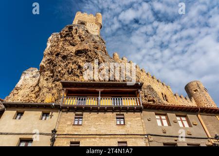 Torre medievale del castello che torreggia in modo imposente sulle vecchie case del villaggio di Frias, Burgos. Foto Stock
