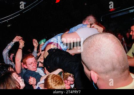 CROWD SURFING, GLAMOURGAN UNIVERSITY, 1996: Giovani fan in mezzo alla folla contro la barriera di sicurezza durante il set Menswear alla Glamorgan University in Galles, Regno Unito, nel marzo 1996. Foto: Rob Watkins Foto Stock