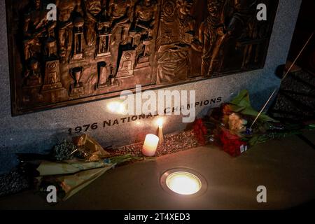 Bloomington, Stati Uniti. 1 novembre 2023. Fiori e una sedia sono collocati alla base della targa del campionato NCAA del 1976 fuori dalla Simon Skjodt Assembly Hall dove Bob Knight, morto, allenò il 1 novembre 2023 a Bloomington, Indiana. Knight allenò la squadra di basket maschile all'interno dell'Assembly Hall e con la sua squadra vinse i campionati NCAA del 1976, 1981 e 1987. (Foto di Jeremy Hogan/SOPA Images/Sipa USA) credito: SIPA USA/Alamy Live News Foto Stock