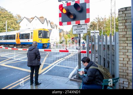 LONDRA, 30 OTTOBRE 2023: Stazione ferroviaria centrale di Acton e attraversamento stradale. London Overland, linea ferroviaria nella zona ovest di Londra Foto Stock