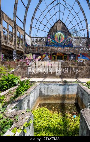 Graffiti di un luogo perduto, un ex parco acquatico e di divertimenti che viene recuperato dalla natura. Taman Festival Bali, Padang Galak, Indonesia Foto Stock