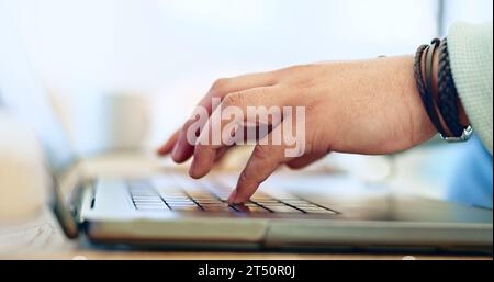 Digitazione, mani e uomo con lavoro remoto su laptop, scrivania e primo piano sul luogo di lavoro in casa. Computer, tastiera e persona che scrive SEO, copywriting o. Foto Stock