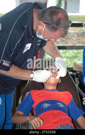 0706197783B-002 BAN SAMSAN, Thailandia (19 giugno 2007) РCmdr. Greg Ganser, un dentista della Marina assegnato al Naval Operational Support Center, esegue un esame dentale di routine su uno studente durante un progetto di azione civile dentale (DENCAP) in una scuola elementare locale durante l'esercizio cooperazione afloat Readiness and Training (KARAT) 2007. KARAT è una serie programmata di esercitazioni militari bilaterali con diverse nazioni del sud-est asiatico progettate per migliorare l'interoperabilità dei rispettivi servizi marittimi. Marina degli Stati Uniti Foto Stock