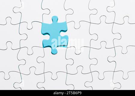 Puzzle in pezzetto blu collegato con sfondo in pezzetto bianco Foto Stock
