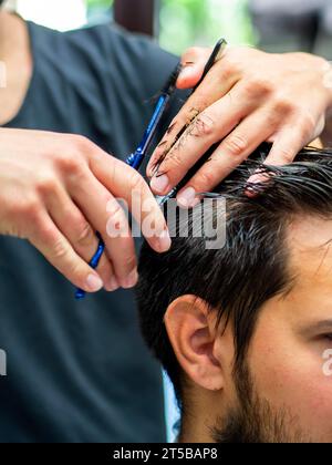 Primo piano per il taglio dei capelli da parte del cliente Foto Stock