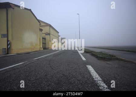 Manor ai margini di una strada in una giornata nebbiosa nella campagna italiana Foto Stock