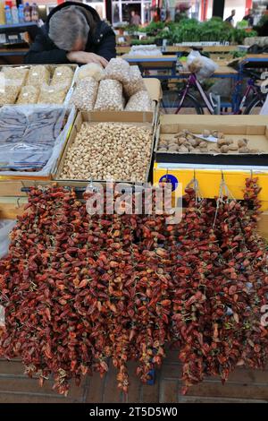 006 fornitore di cuccioli in un mercato che vende arachidi-fichi-pistacchi-noci e peperoncini secchi, Pazari i Ri-New Bazaar. Tirana-Albania. Foto Stock