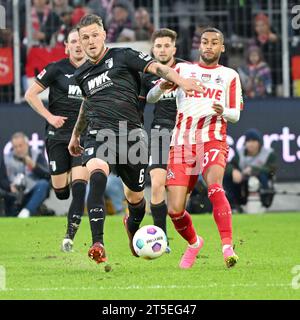 Colonia, Germania. 4 novembre 2023. Linton Maina (R) di Colonia vies con Jeffrey Gouweleeuw di Augusta durante la prima divisione della bundesliga match tra FC Colonia e FC Augsburg a Colonia, Germania, 4 novembre 2023. Crediti: Ulrich Hufnagel/Xinhua/Alamy Live News Foto Stock