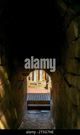 All'interno di uno degli ingressi che conducono alle tribune e al palcoscenico dell'antico Teatro Romano di Mérida, con un soffitto a volta di blocchi di roccia poco luminoso Foto Stock