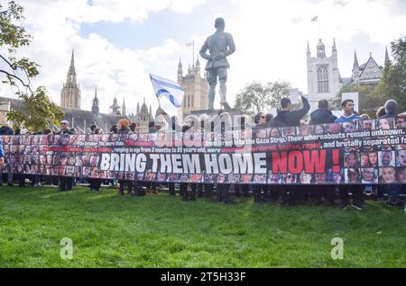 Londra, Regno Unito. 5 novembre 2023. I manifestanti tengono in mano uno striscione "portali a casa ora" durante la dimostrazione. Migliaia di persone si sono riunite in Piazza del Parlamento per il raduno Bring Them Home per gli ostaggi israeliani detenuti da Hamas a Gaza. Credito: SOPA Images Limited/Alamy Live News Foto Stock