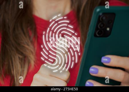 La ragazza preme le dita sull'impronta digitale virtuale del telefono, la password e la sicurezza dei dati, la tecnologia Foto Stock