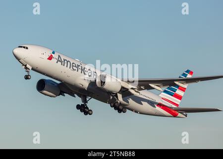 Un Boeing 777-323ER dell'American Airlines che sale da Londra Heathrow in una bella serata d'oro Foto Stock