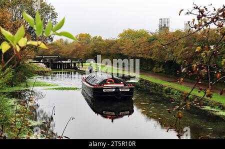 La barca galleggiante "Kennet" è salita attraverso la chiusa 67 e ha due chiuse per raggiungere la cima della rampa di chiuse di Wigan Foto Stock