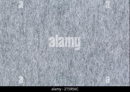 Texture in feltro, primo piano. Materiale in feltro grigio tenue. Superficie in tessuto feltrato. Sfondo astratto di colore grigio. Foto Stock