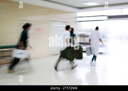 Gli operatori sanitari si sono precipitati oltre la sala di trattamento di emergenza, primo piano della foto Foto Stock