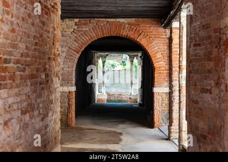 Antica sala ad arco vuota o passaggio in mattoni con travi in legno a Venezia, Italia Foto Stock