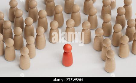Concetto di discriminazione e inclusione. Le statuette di legno circondano il rendering rosso.3D su sfondo bianco. Foto Stock