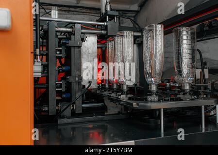 La forma della preforma del flacone in PET nella pressa per soffiaggio dello stampo. Il funzionamento della lavorazione delle bottiglie in PET mediante processo di soffiaggio con lo stampo soffiante. Foto Stock