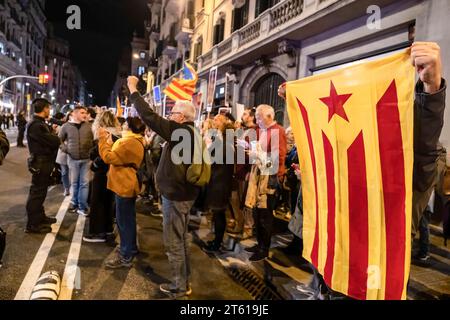 Barcellona, Spagna. 7 novembre 2023. Un manifestante detiene la bandiera dell'indipendenza della Catalogna durante la manifestazione. Una cinquantina di nazionalisti spagnoli con bandiere hanno cercato di rompere un evento chiamato dalla Commissione della dignità davanti alla stazione di polizia di Vía Laietana per chiedere che la stazione di polizia, l'ex quartier generale della polizia francosta, sia convertita in un Centro di interpretazione e memoria della repressione . Credito: SOPA Images Limited/Alamy Live News Foto Stock