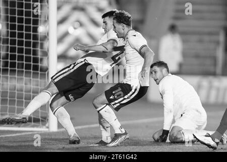 Shrewsbury, Regno Unito. 7 novembre 2023. George Thomason e Dion Charles di Bolton in azione attaccante mentre il pallone passa oltre il portiere di Shrewsbury, Marko Maroši per mettere i visitatori davanti a sé durante la partita EFL Sky Bet League 1 tra Shrewsbury Town e Bolton Wanderers a Croud Meadow, Shrewsbury, Inghilterra il 7 novembre 2023. Foto di Stuart Leggett. Solo per uso editoriale, licenza necessaria per uso commerciale. Nessun utilizzo in scommesse, giochi o pubblicazioni di un singolo club/campionato/giocatore. Credito: UK Sports Pics Ltd/Alamy Live News Foto Stock