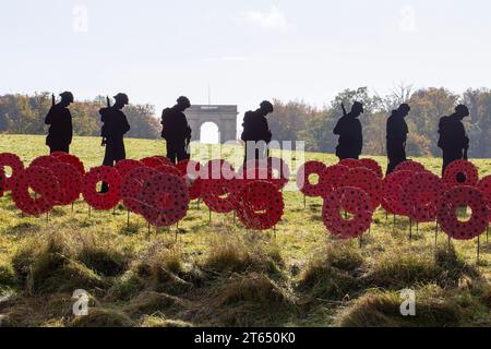 Silhouette e papaveri in metallo in PIEDI CON L'installazione artistica GIANTS Remembrance Day presso Stowe Gardens, Buckinghamshire, Inghilterra 11/2023 Foto Stock