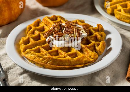 Colazione fatta in casa, waffle alla zucca con noci pecan e panna montata Foto Stock