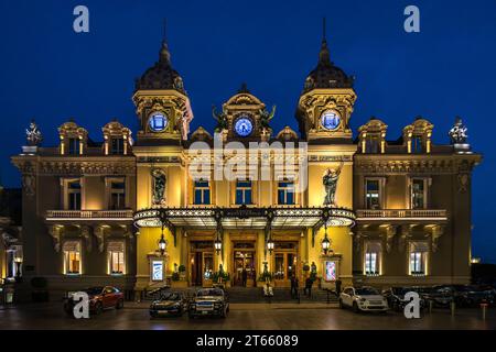 Monaco, 15 febbraio 2023: Il Casinò di Monte Carlo illuminato con auto di lusso di fronte la sera. Foto Stock