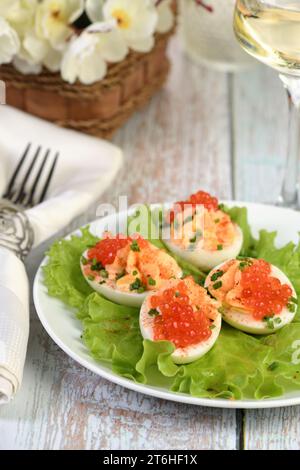 Uova ripiene con caviale di salmone sono un antipasto popolare per ogni occasione. Elegantemente decorate e sapientemente condite, saranno sempre una bella A. Foto Stock